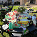 Outdoor setting of a special event with the tables covered in colorful round custom logo tablecloth featuring  brand logos of the sponsors. The logo tablecloth is printed by Premier Table Linens.