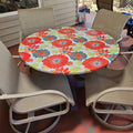 Round fitted oilcloth tablecloth with red floral pattern on patio table, Premier Table Linens